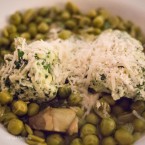 Vignarola (light Italian broth of broad beans, the first peas, and baby artichokes) with ricotta and herb dumplings.